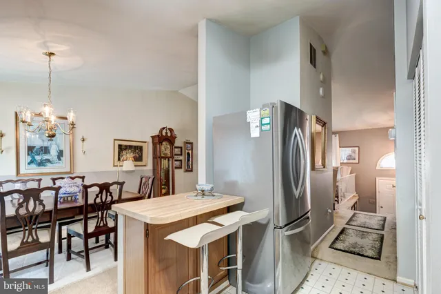 a kitchen with refrigerator cabinets dining table and chairs