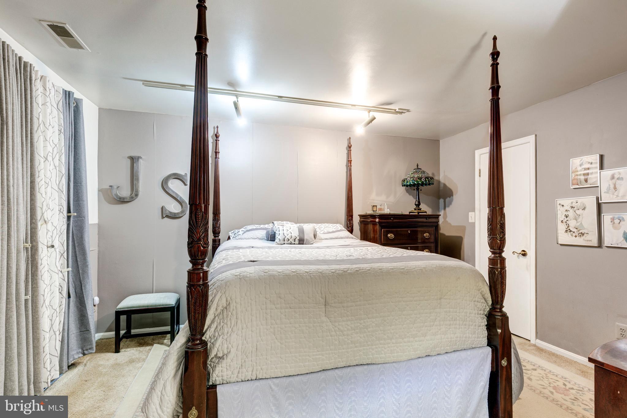 502 Brighton Place Baltimore, MD 21221 - Photo 25 of 42 a en suite bathroom with a double vanity sink and a mirror
