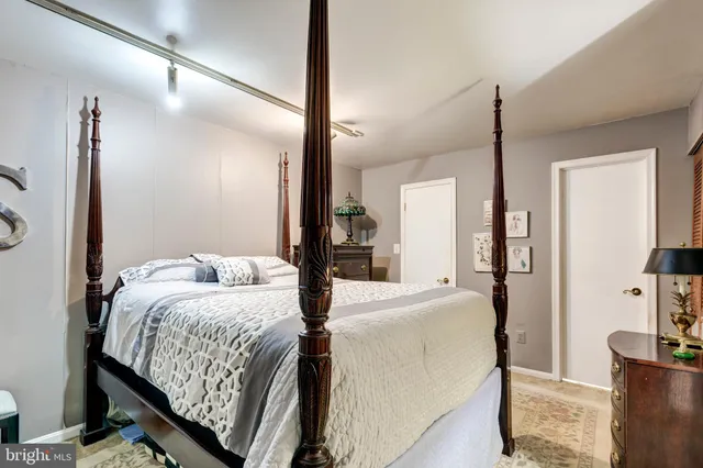 a bedroom with a large bed and a chandelier