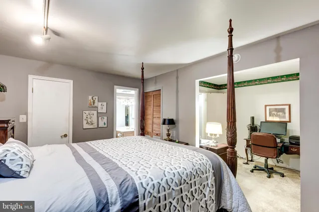 a bedroom with a bed window and chair