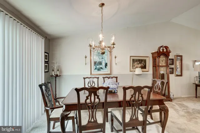 a view of a dining room with furniture and chandelier