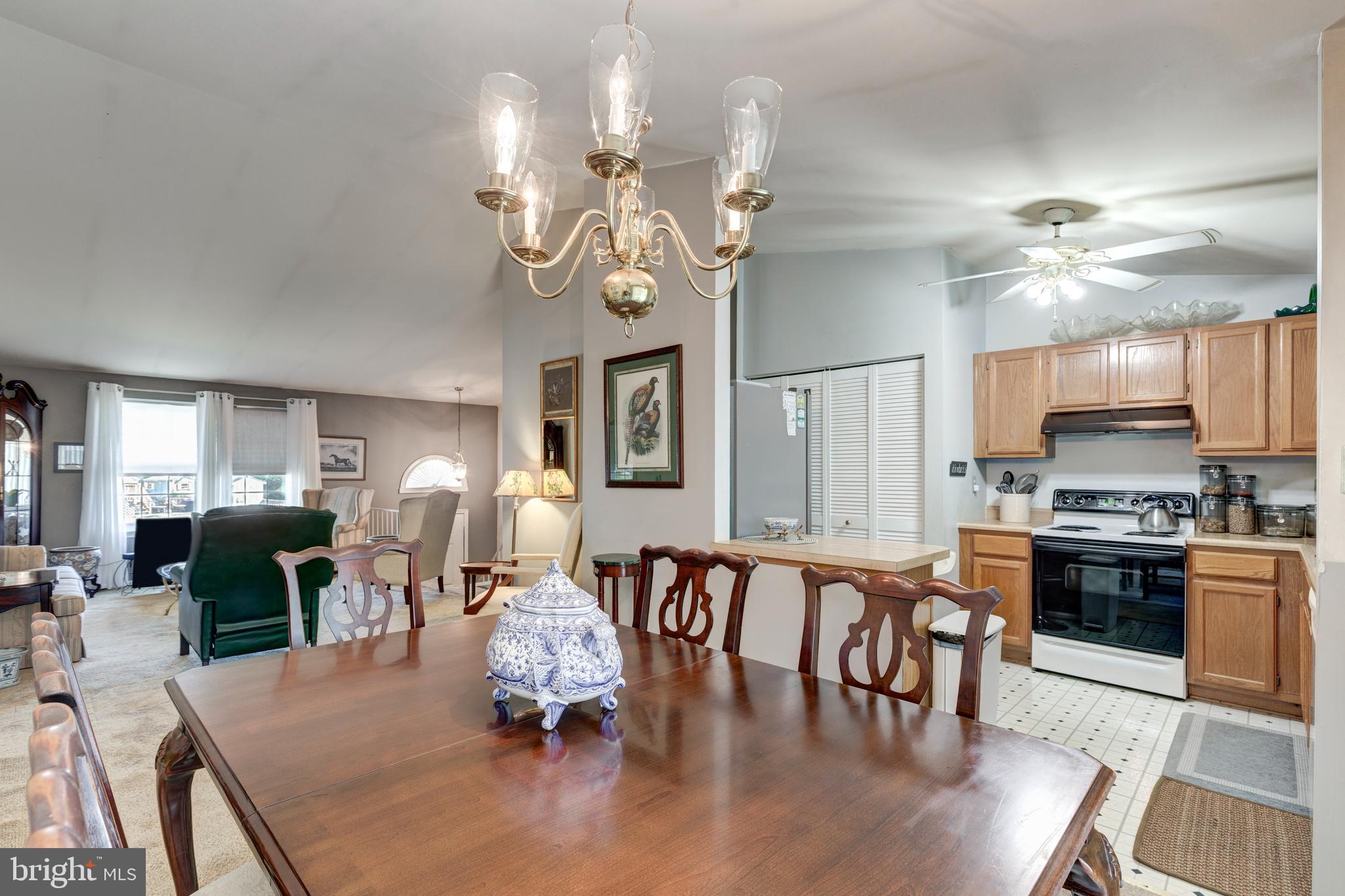 502 Brighton Place Baltimore, MD 21221 - Photo 10 of 42 a view of a dining room with furniture a chandelier and wooden floor