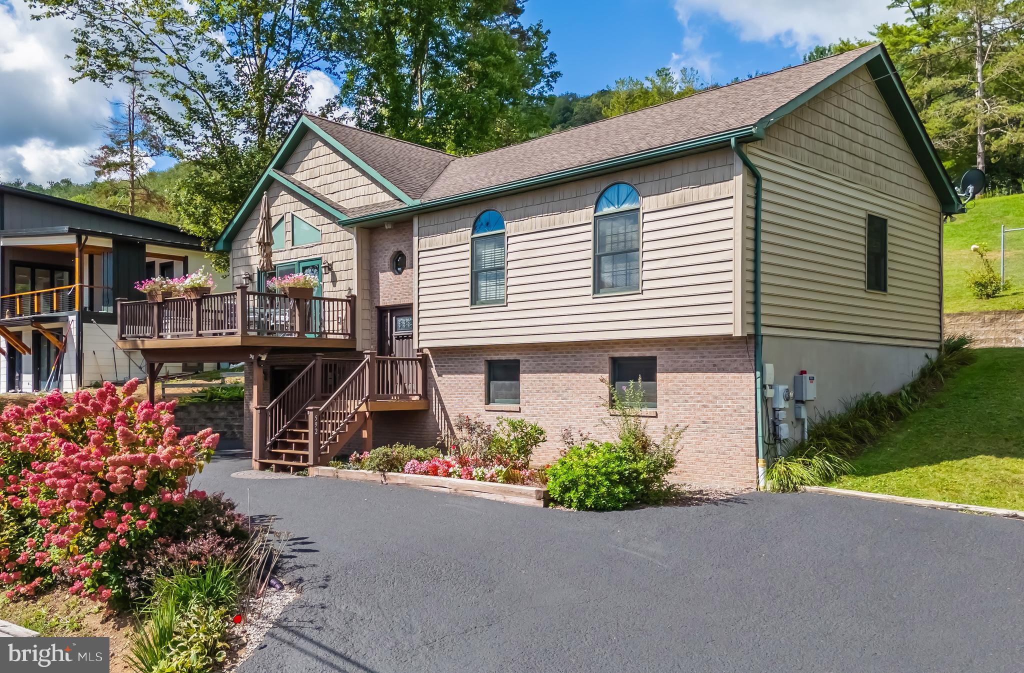 592 Marsh Hill Road McHenry, MD 21541 - Photo 1 of 51 a front view of a house with garden