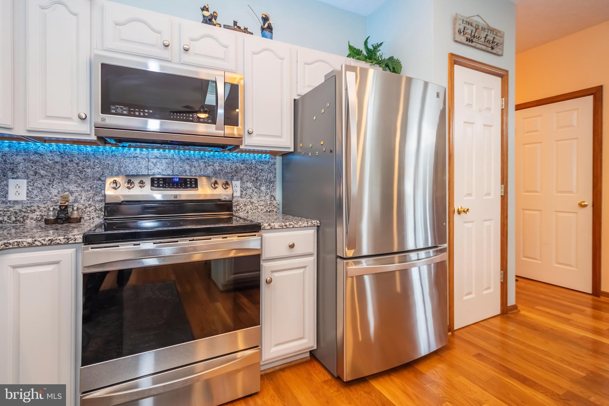 592 Marsh Hill Road McHenry, MD 21541 - Photo 11 of 51 a kitchen with granite countertop a refrigerator stove and microwave