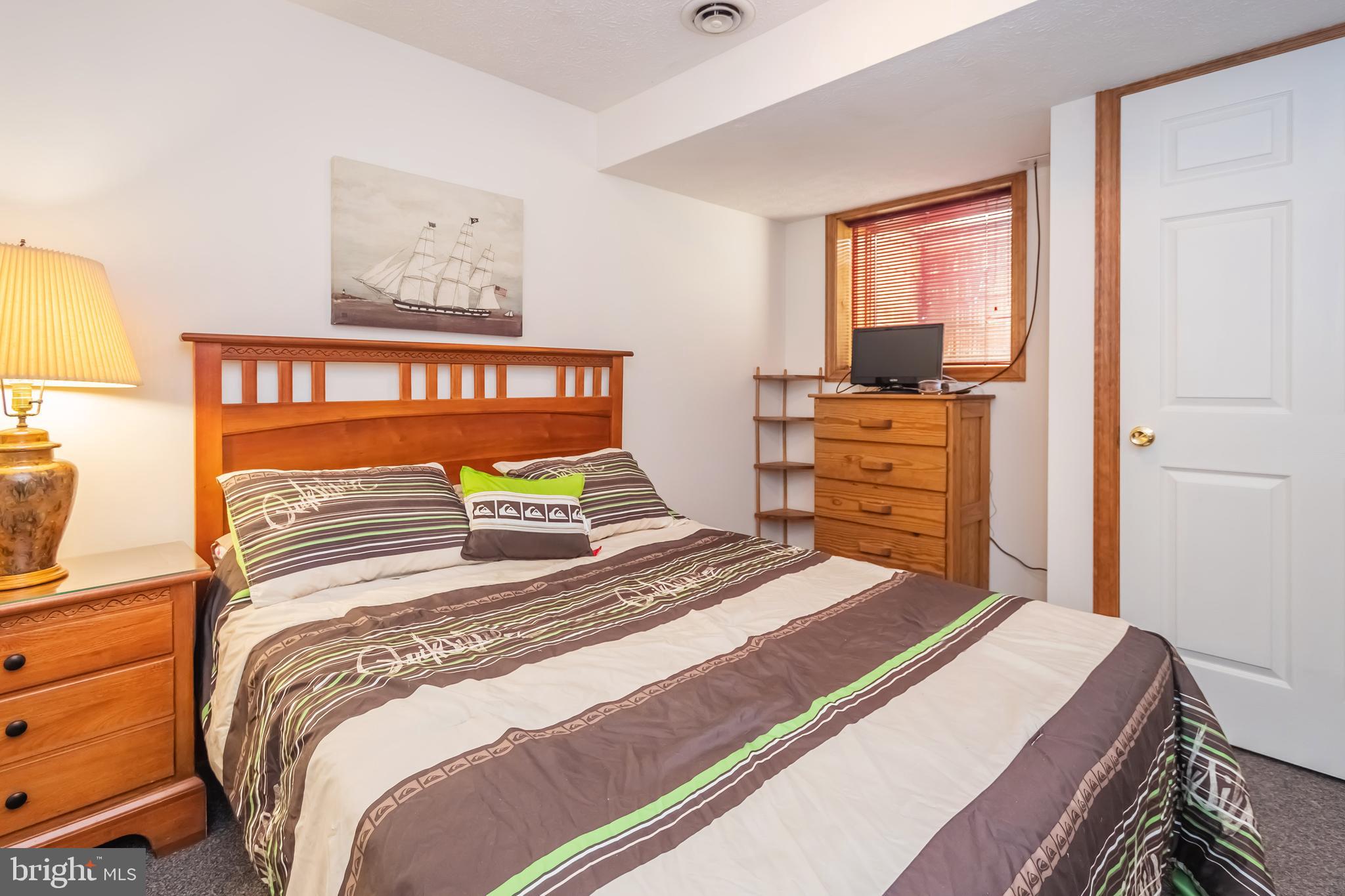 592 Marsh Hill Road McHenry, MD 21541 - Photo 32 of 51 a bedroom with a bed and a dresser in it