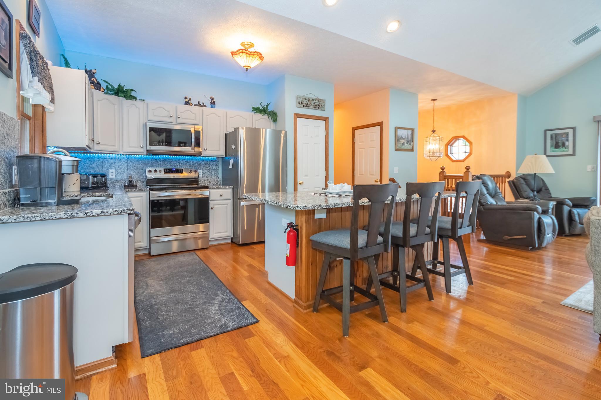 592 Marsh Hill Road McHenry, MD 21541 - Photo 9 of 51 a living room with stainless steel appliances granite countertop furniture wooden floor and a kitchen view