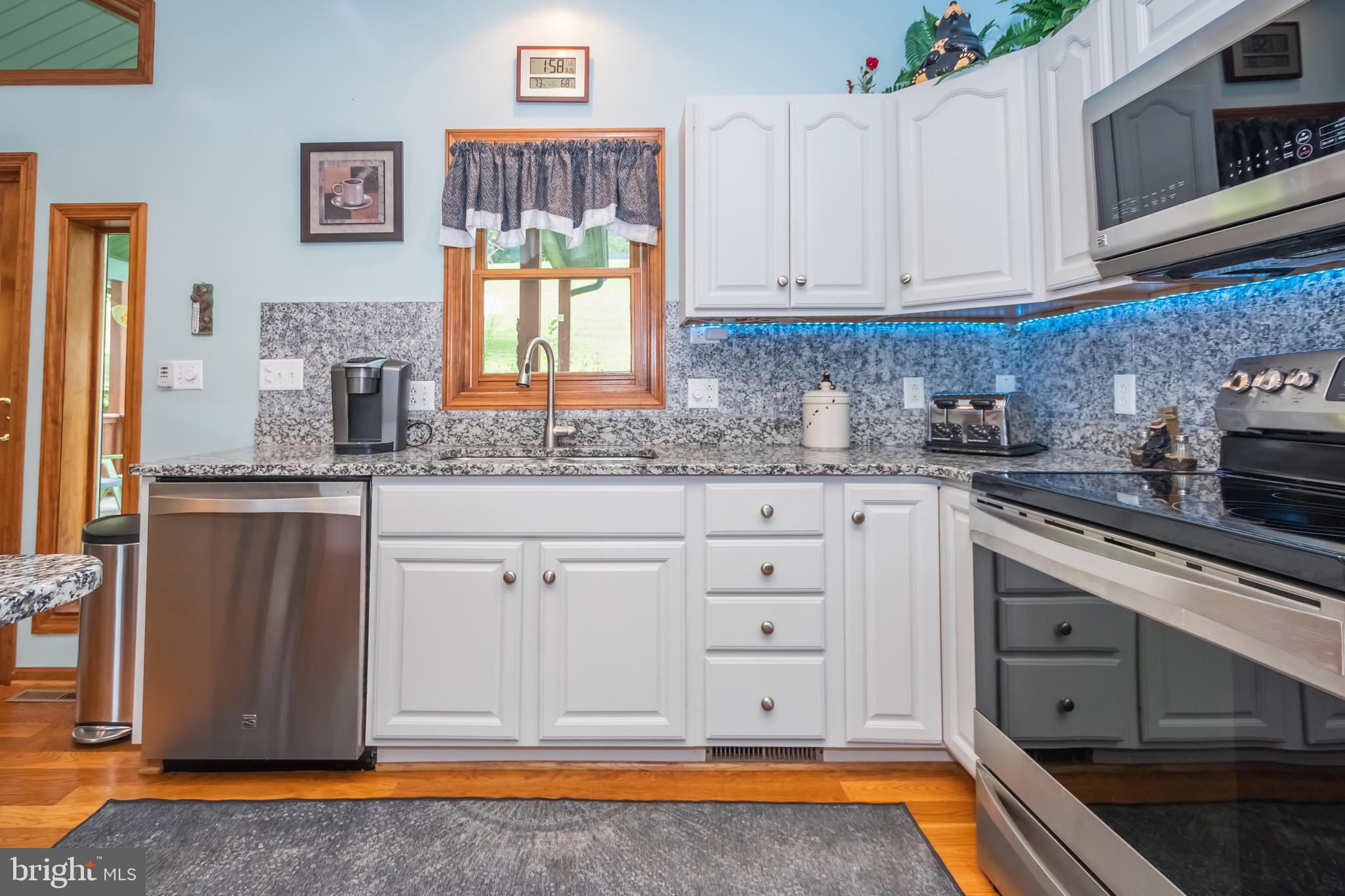 592 Marsh Hill Road McHenry, MD 21541 - Photo 10 of 51 a kitchen with stainless steel appliances granite countertop a sink stove and cabinets