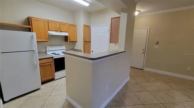 a kitchen with stainless steel appliances a refrigerator and a stove top oven
