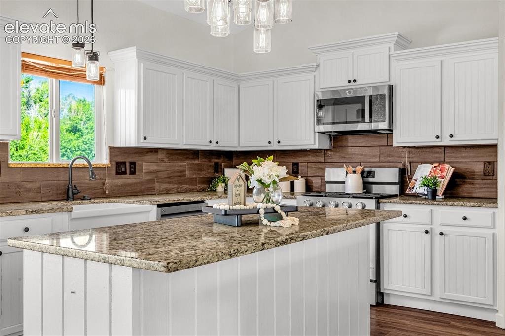 11185 Falling Star Road Fountain, CO 80817 - Photo 7 of 46 a kitchen with stainless steel appliances granite countertop a sink a stove and a granite counter tops