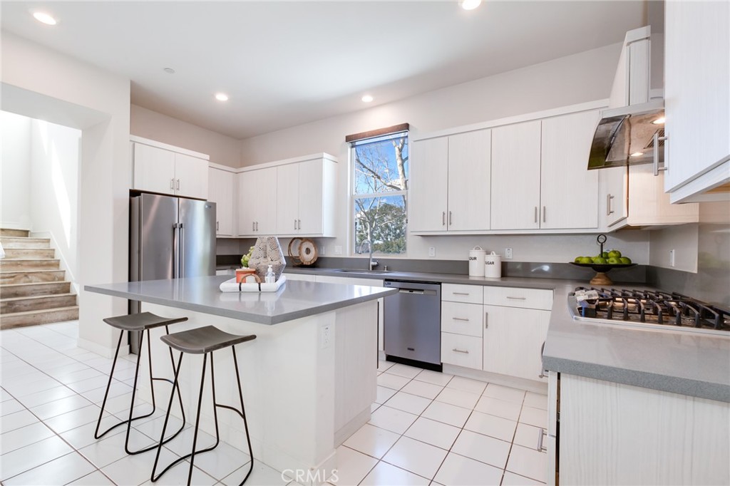 800 Beacon Irvine, CA 92618 - Photo 12 of 49 a kitchen with stainless steel appliances granite countertop a stove a sink a refrigerator and white cabinets