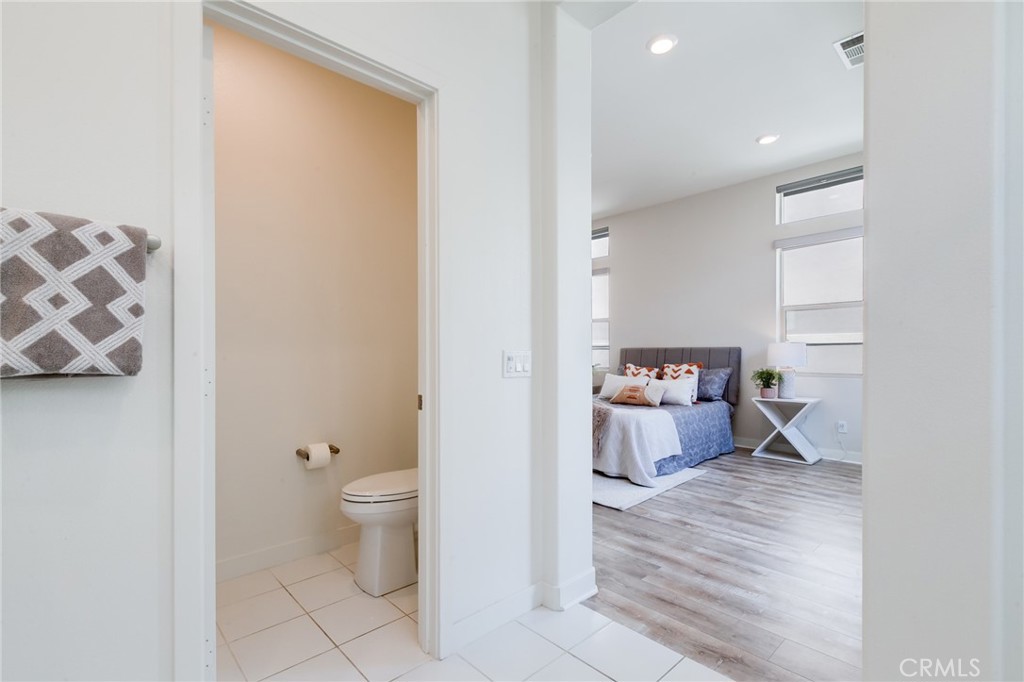 800 Beacon Irvine, CA 92618 - Photo 26 of 49 a view of a hallway with wooden floor and a bathroom
