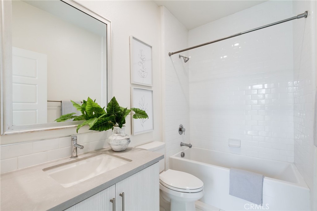 800 Beacon Irvine, CA 92618 - Photo 29 of 49 a bathroom with a granite countertop sink a toilet and a bathtub