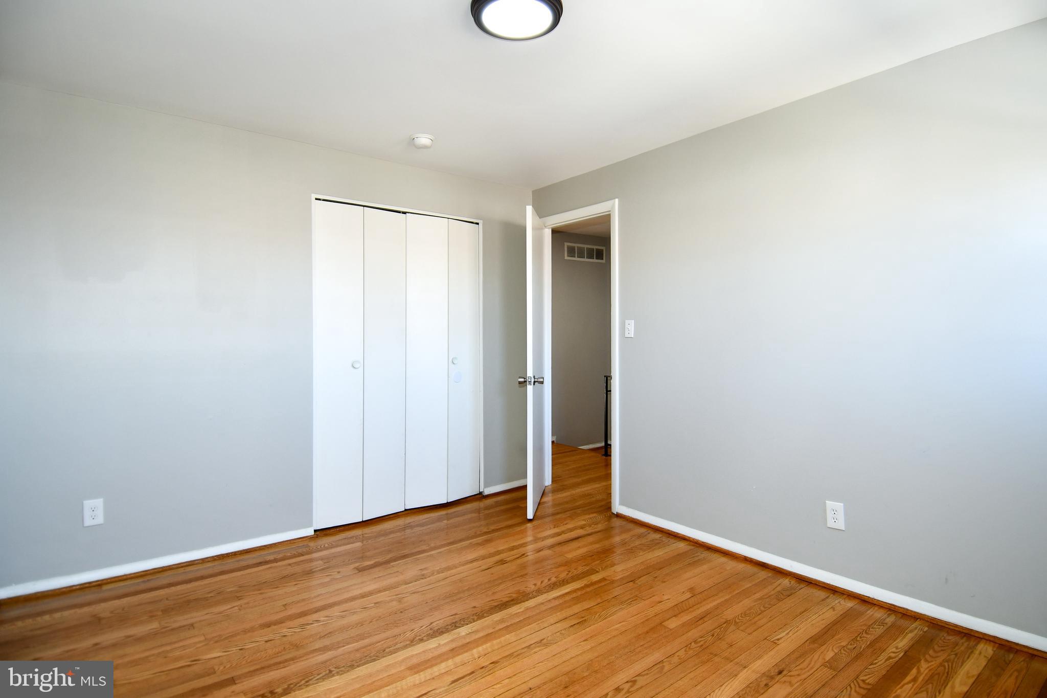 4223 Labyrinth Road Baltimore, MD 21215 - Photo 12 of 22 a view of an empty room with wooden floor