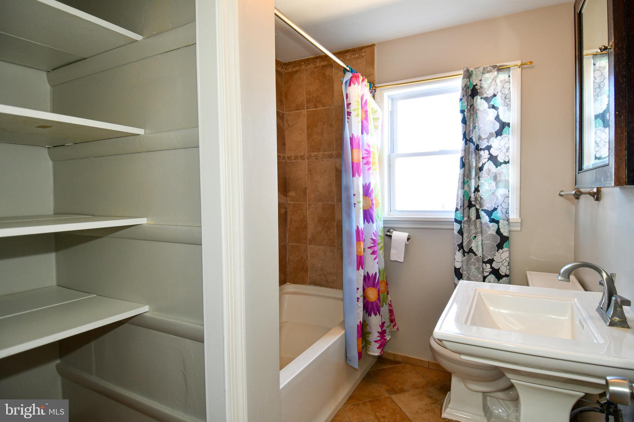 4223 Labyrinth Road Baltimore, MD 21215 - Photo 14 of 22 a bathroom with a sink and a toilet