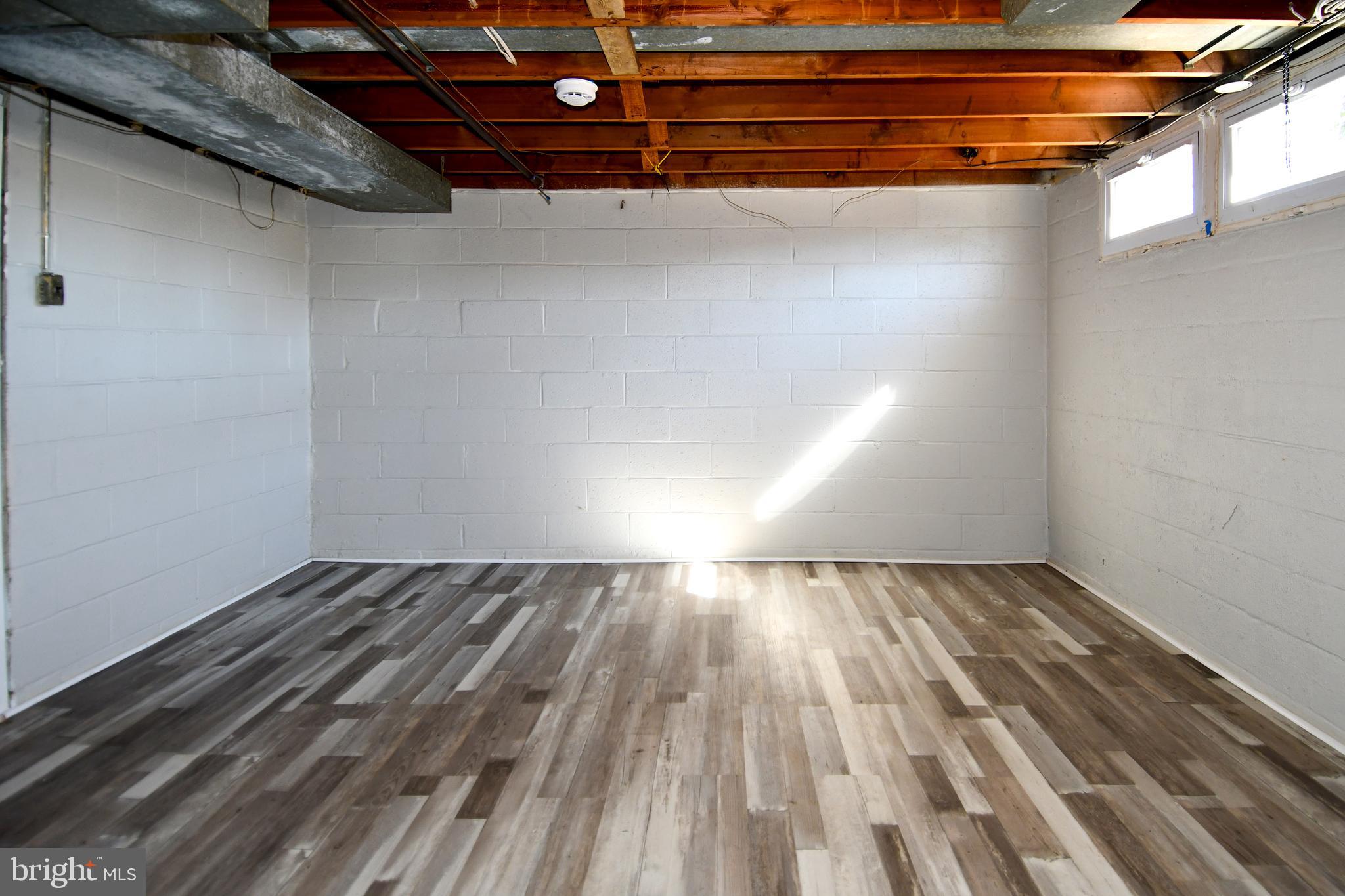 4223 Labyrinth Road Baltimore, MD 21215 - Photo 18 of 22 a view of an empty room with wooden floor