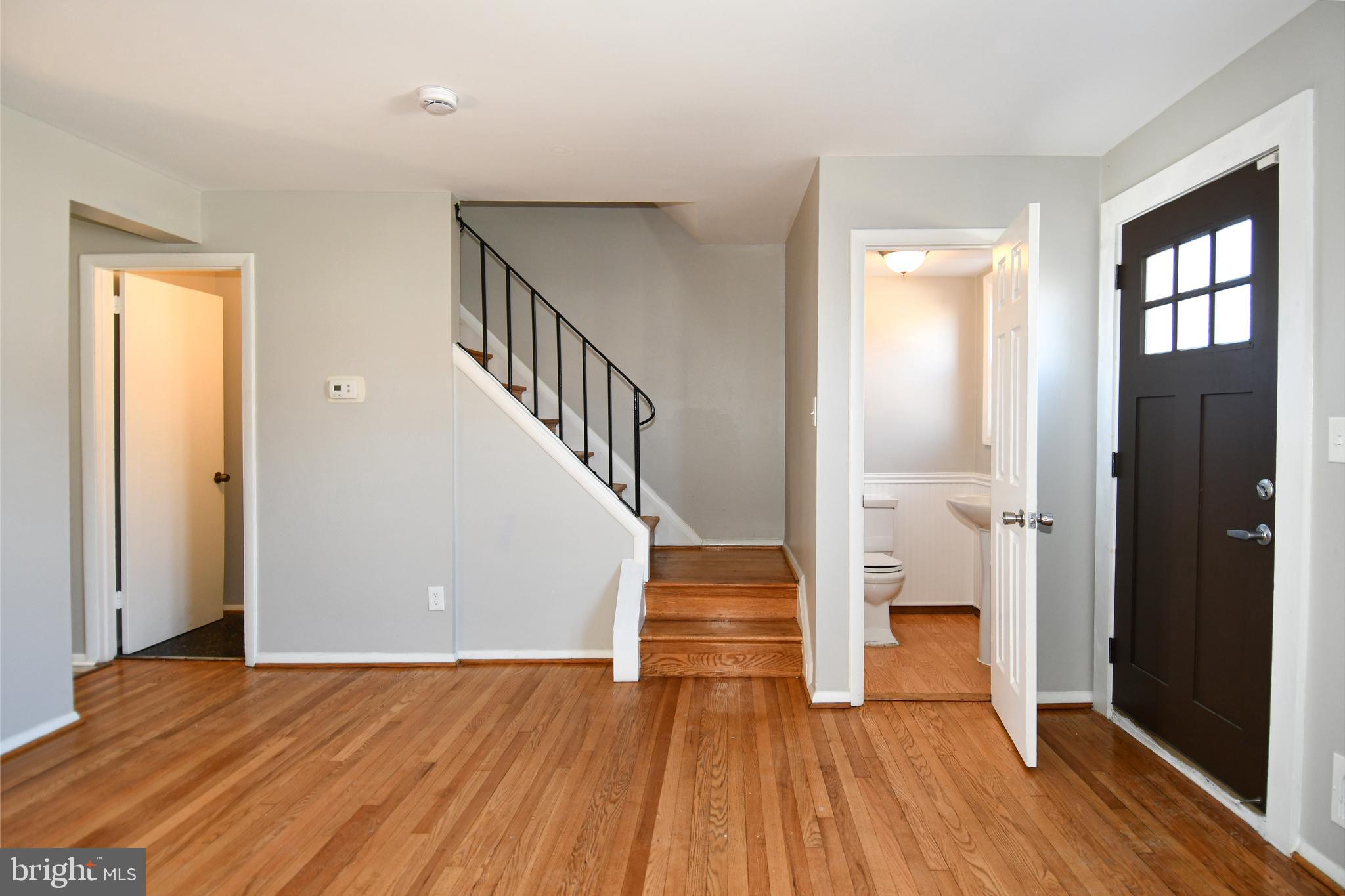 4223 Labyrinth Road Baltimore, MD 21215 - Photo 4 of 22 a view of entryway with wooden floor and stairs