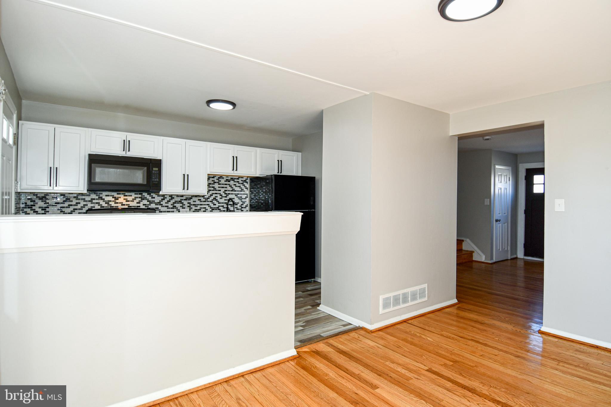4223 Labyrinth Road Baltimore, MD 21215 - Photo 5 of 22 a large white kitchen with a sink and dishwasher