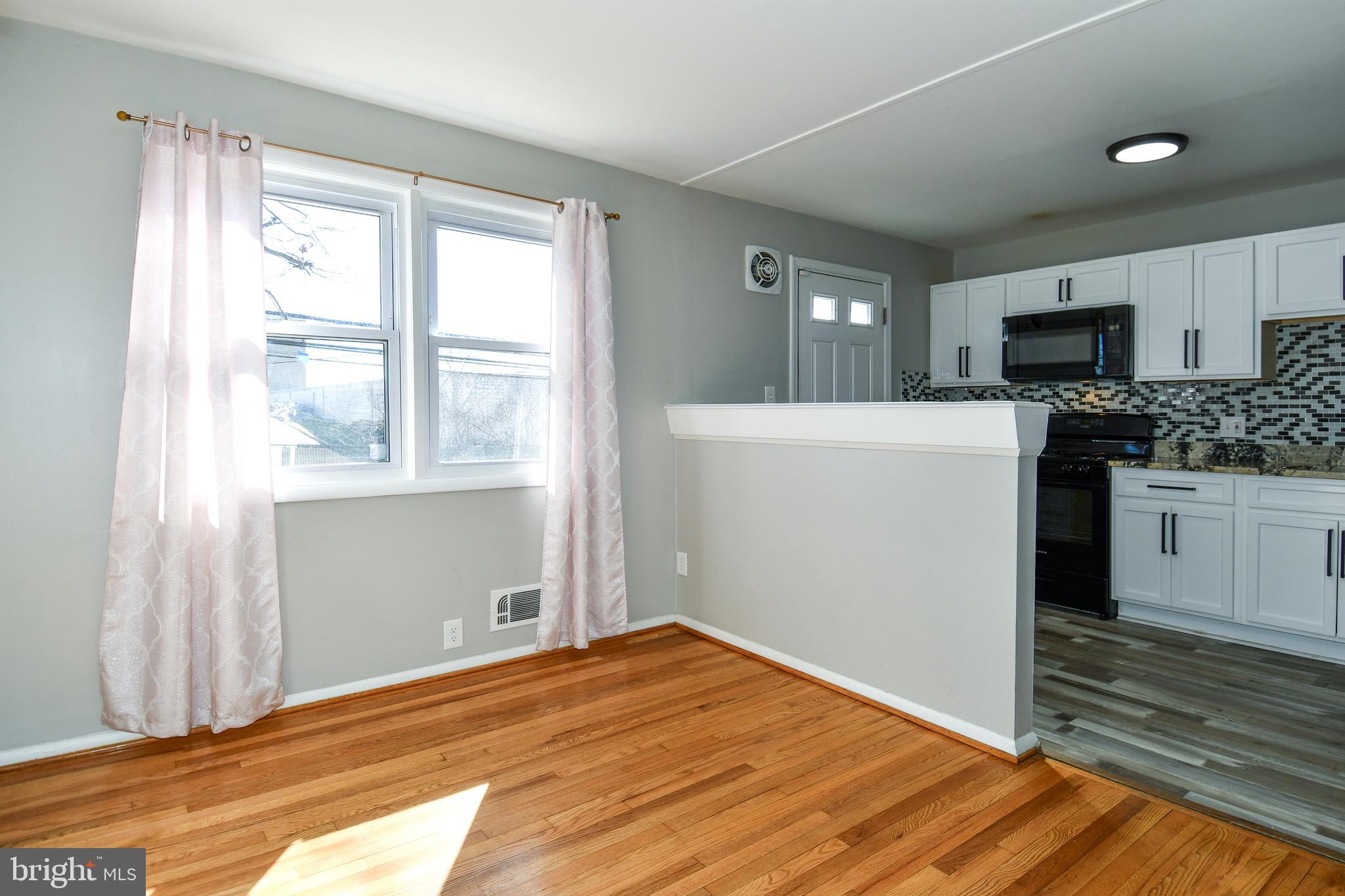 4223 Labyrinth Road Baltimore, MD 21215 - Photo 6 of 22 a kitchen with a refrigerator and a stove top oven