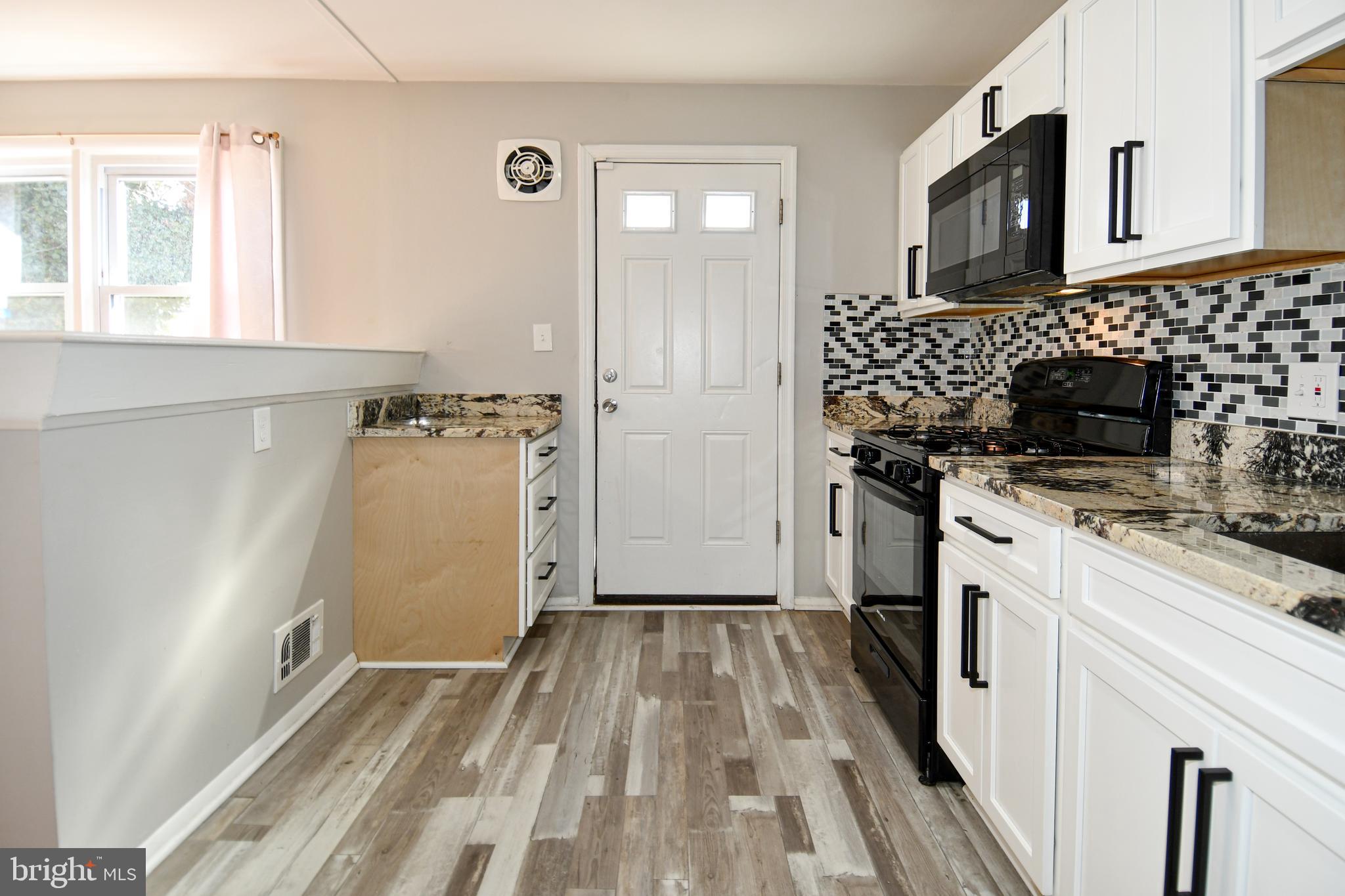 4223 Labyrinth Road Baltimore, MD 21215 - Photo 8 of 22 a kitchen with a refrigerator stove and sink