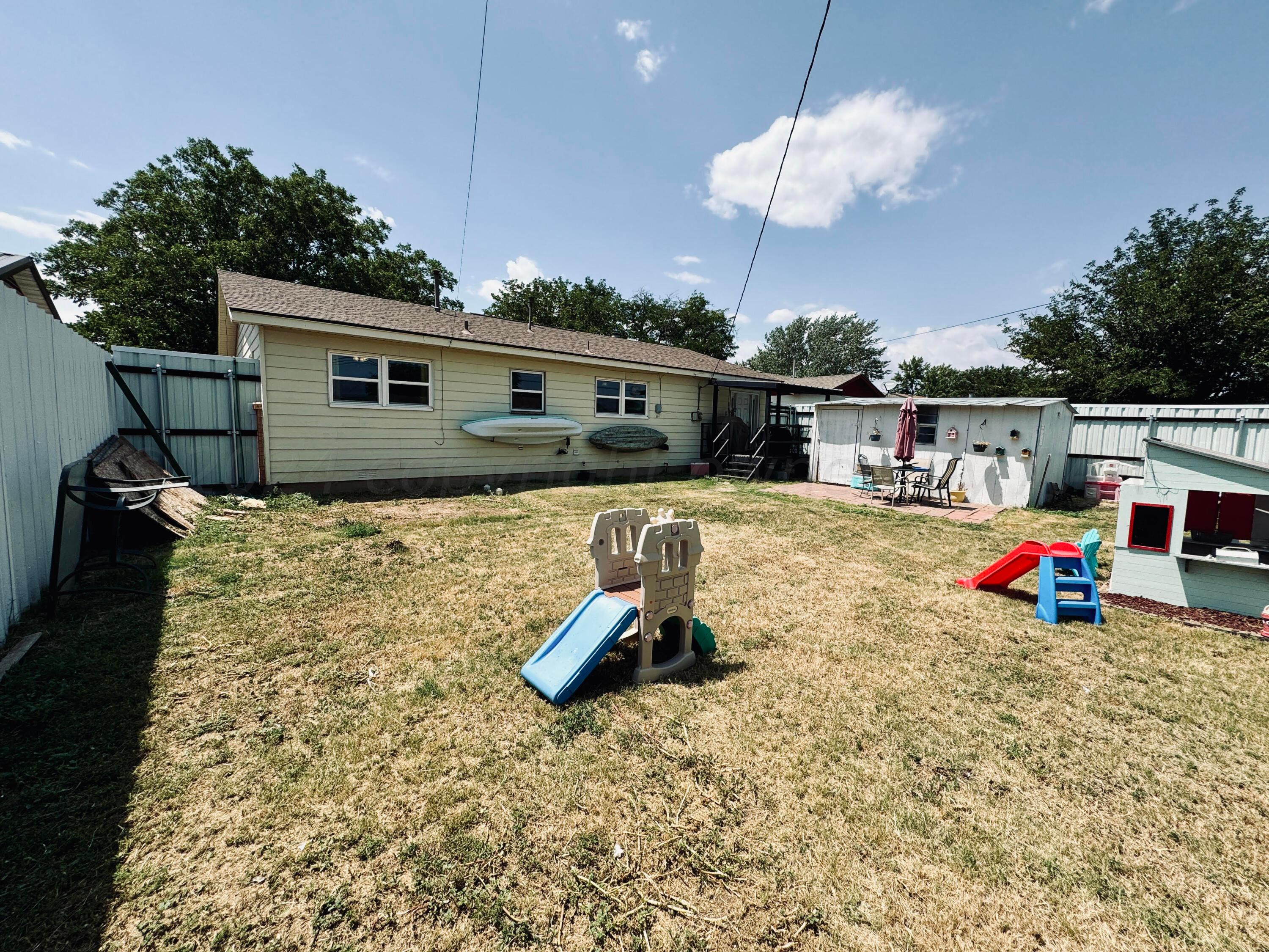 5311 Tumbleweed Drive Amarillo, TX 79110 - Photo 13 of 13 a backyard of a house with table and chairs
