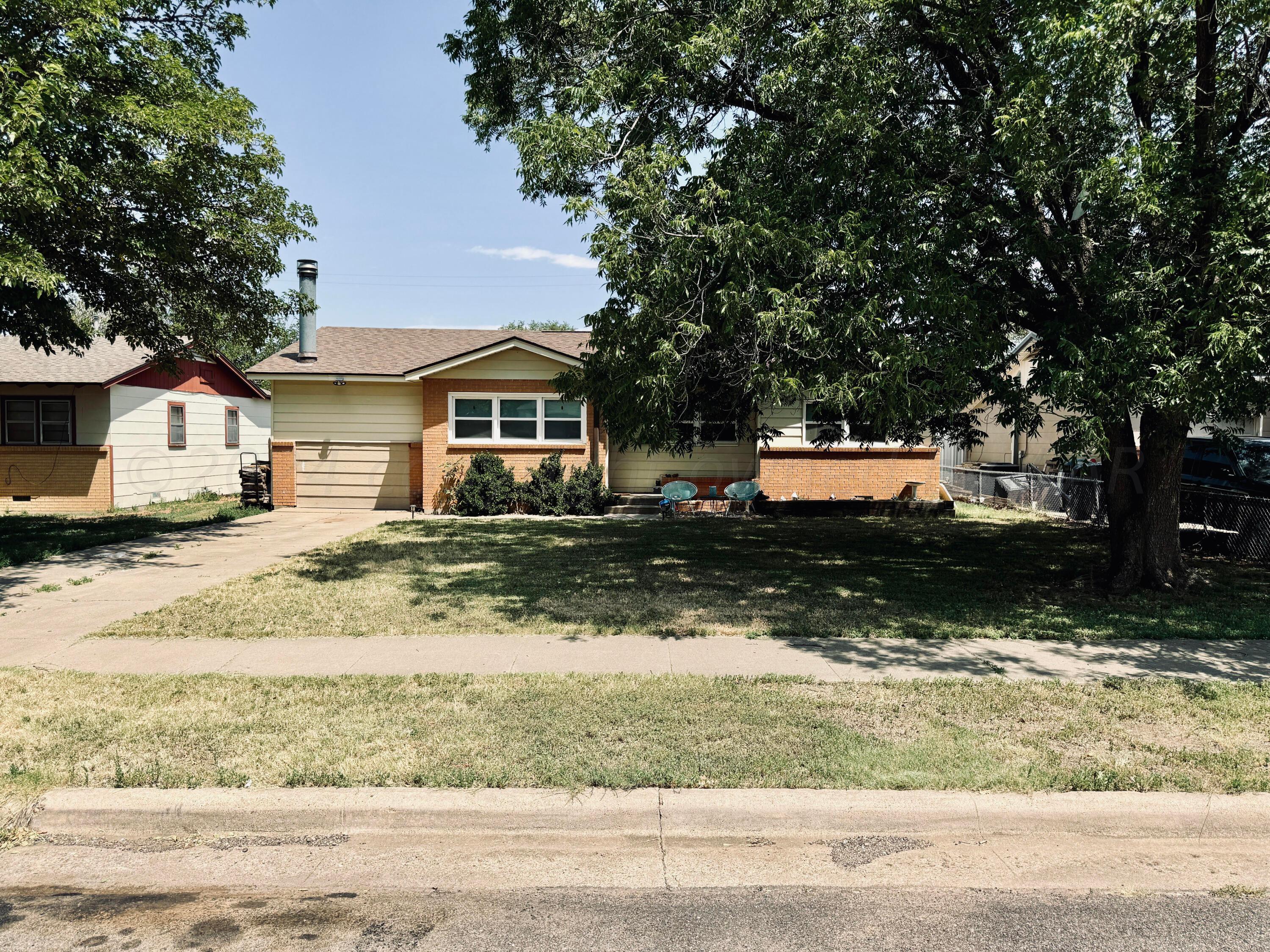 5311 Tumbleweed Drive Amarillo, TX 79110 - Photo 2 of 13 a front view of a house with a yard