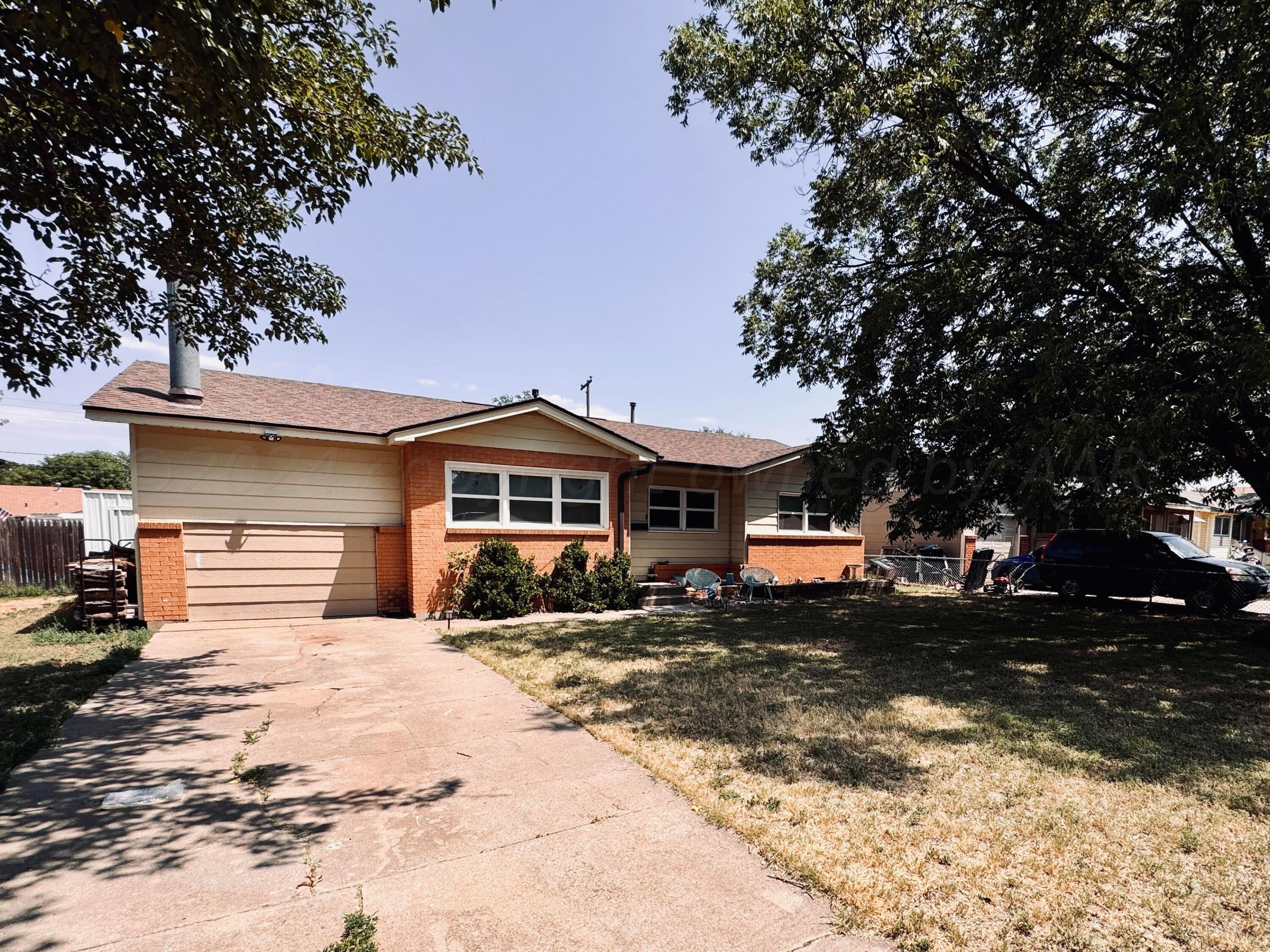 5311 Tumbleweed Drive Amarillo, TX 79110 - Photo 3 of 13 a front view of a house with a yard