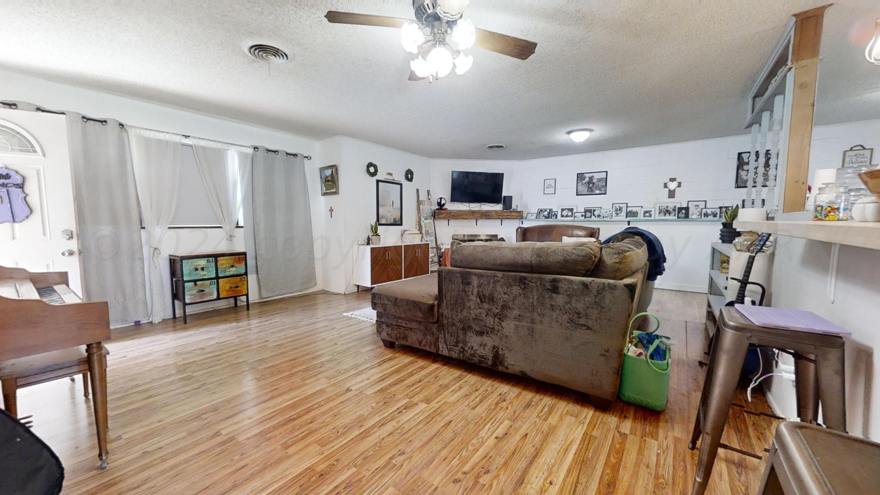 5311 Tumbleweed Drive Amarillo, TX 79110 - Photo 4 of 13 a living room with furniture and a wooden floor