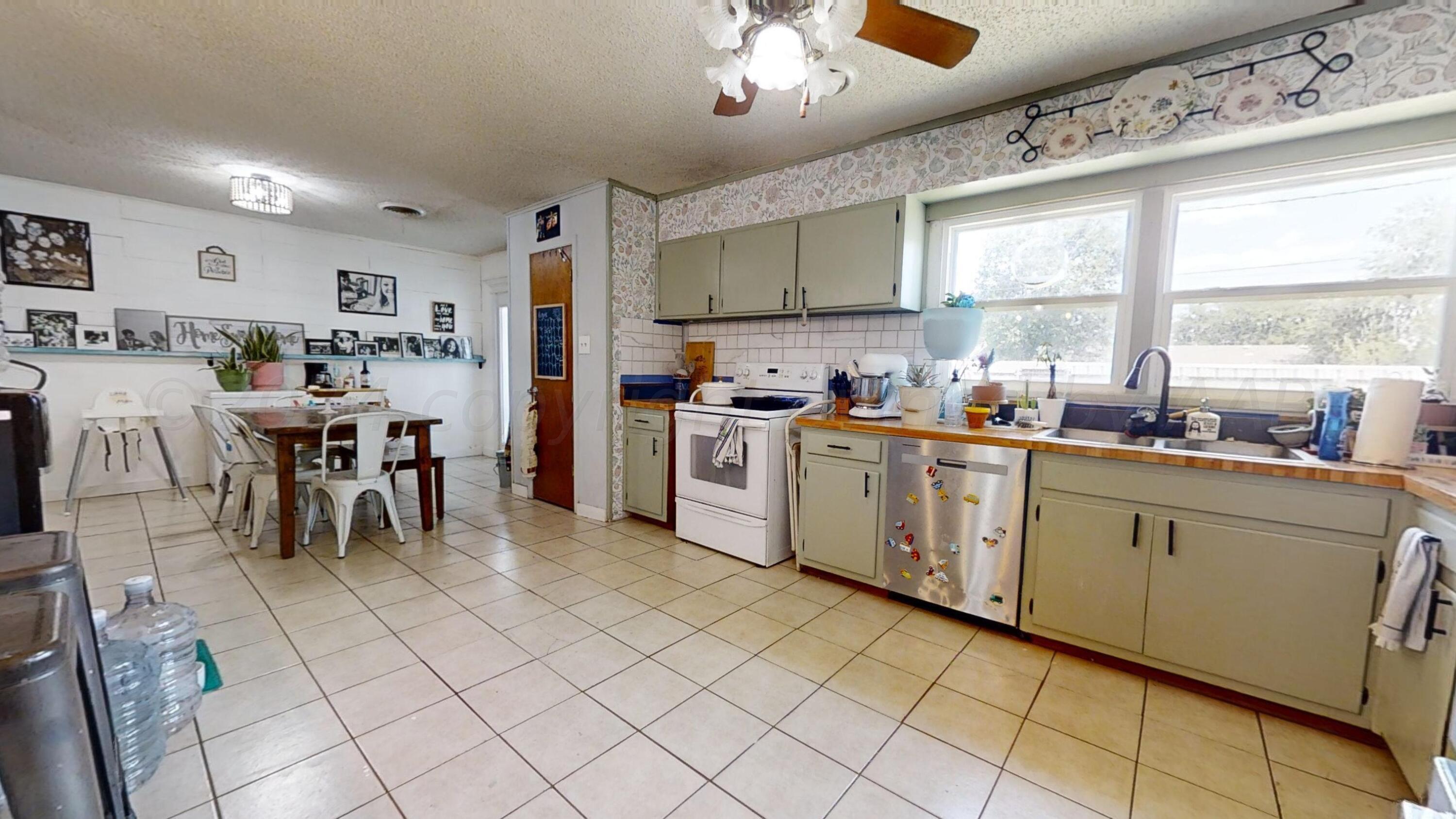 5311 Tumbleweed Drive Amarillo, TX 79110 - Photo 5 of 13 a kitchen with cabinets and chairs