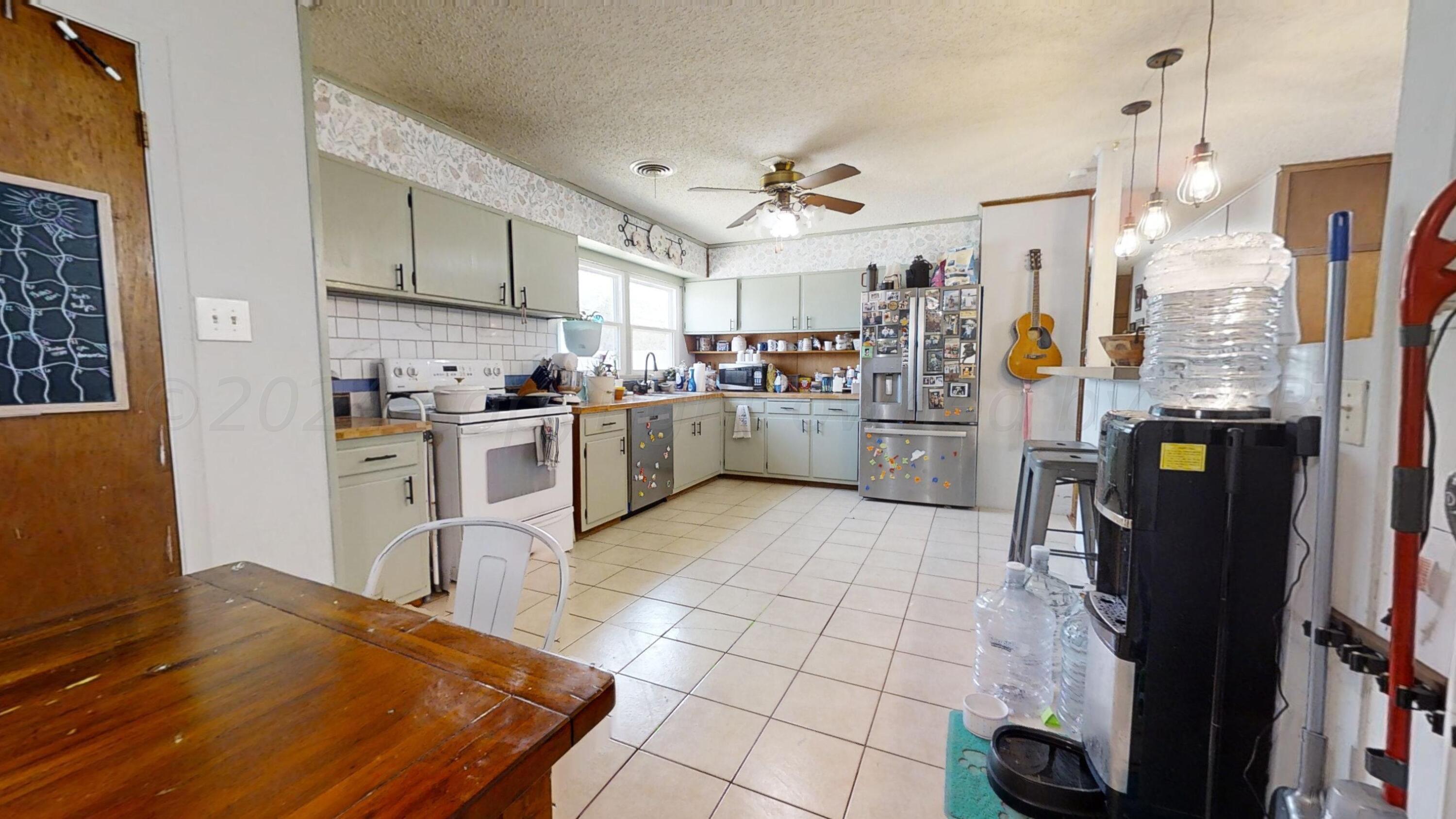 5311 Tumbleweed Drive Amarillo, TX 79110 - Photo 6 of 13 a kitchen with stainless steel appliances granite countertop a refrigerator and a stove top oven