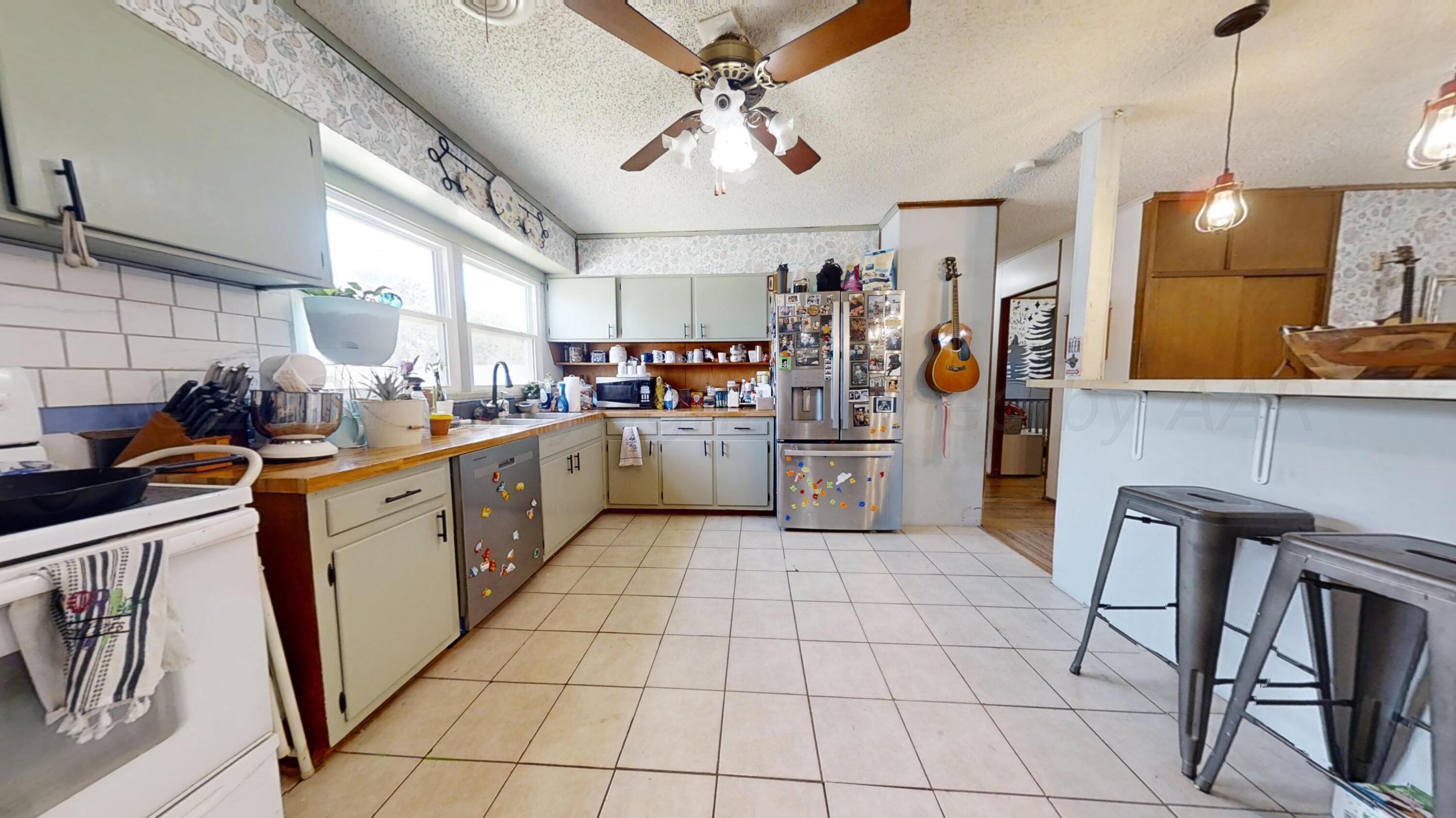 5311 Tumbleweed Drive Amarillo, TX 79110 - Photo 7 of 13 a kitchen with a sink a refrigerator and cabinets