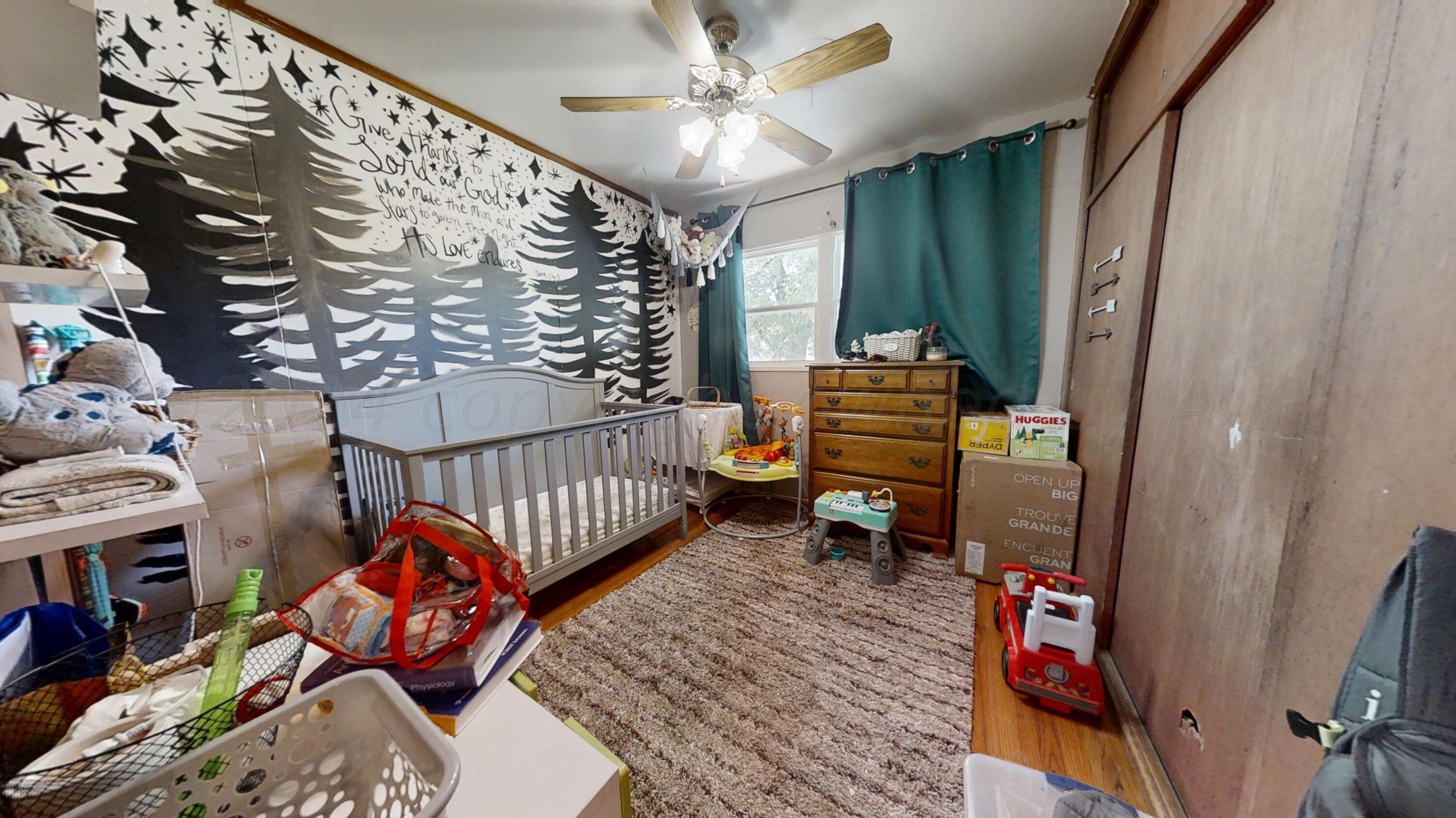 5311 Tumbleweed Drive Amarillo, TX 79110 - Photo 8 of 13 a bedroom with furniture and wooden floor