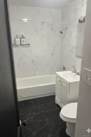 a bathroom with a sink a toilet and a bathtub
