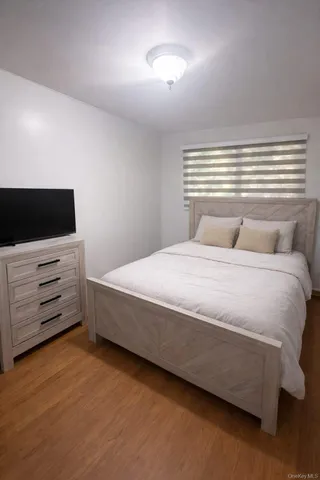 a bedroom with a bed and flat screen tv