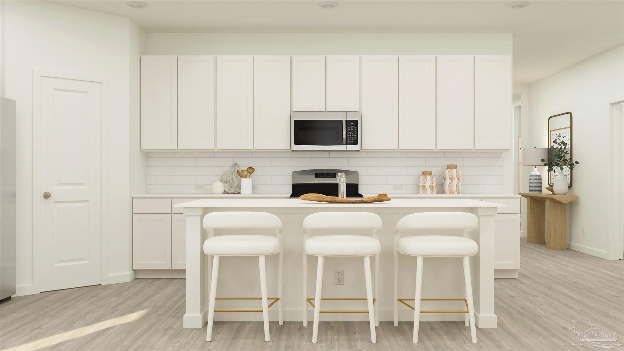 5958 Briarcliff Lane Pace, FL 32571 - Photo 4 of 23 a white kitchen with a sink and cabinets