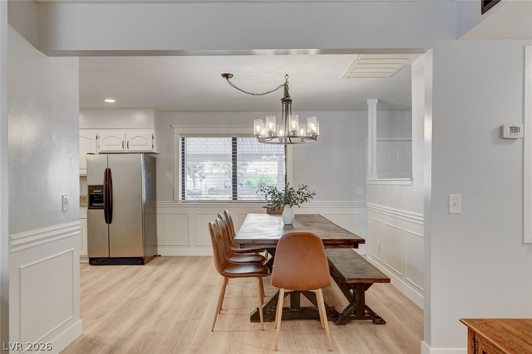 3765 Berkeley Street Logandale, NV 89021 - Photo 21 of 87 This bright dining area offers ample space for gatherings, featuring LVP flooring and modern light fixtures.