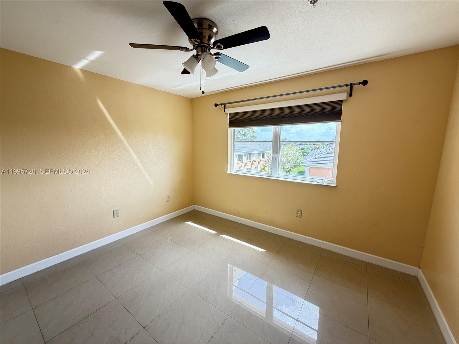 7080 Northwest 177th Street, Unit 20913 Hialeah, FL 33015 - Photo 12 of 15 an empty room with a window