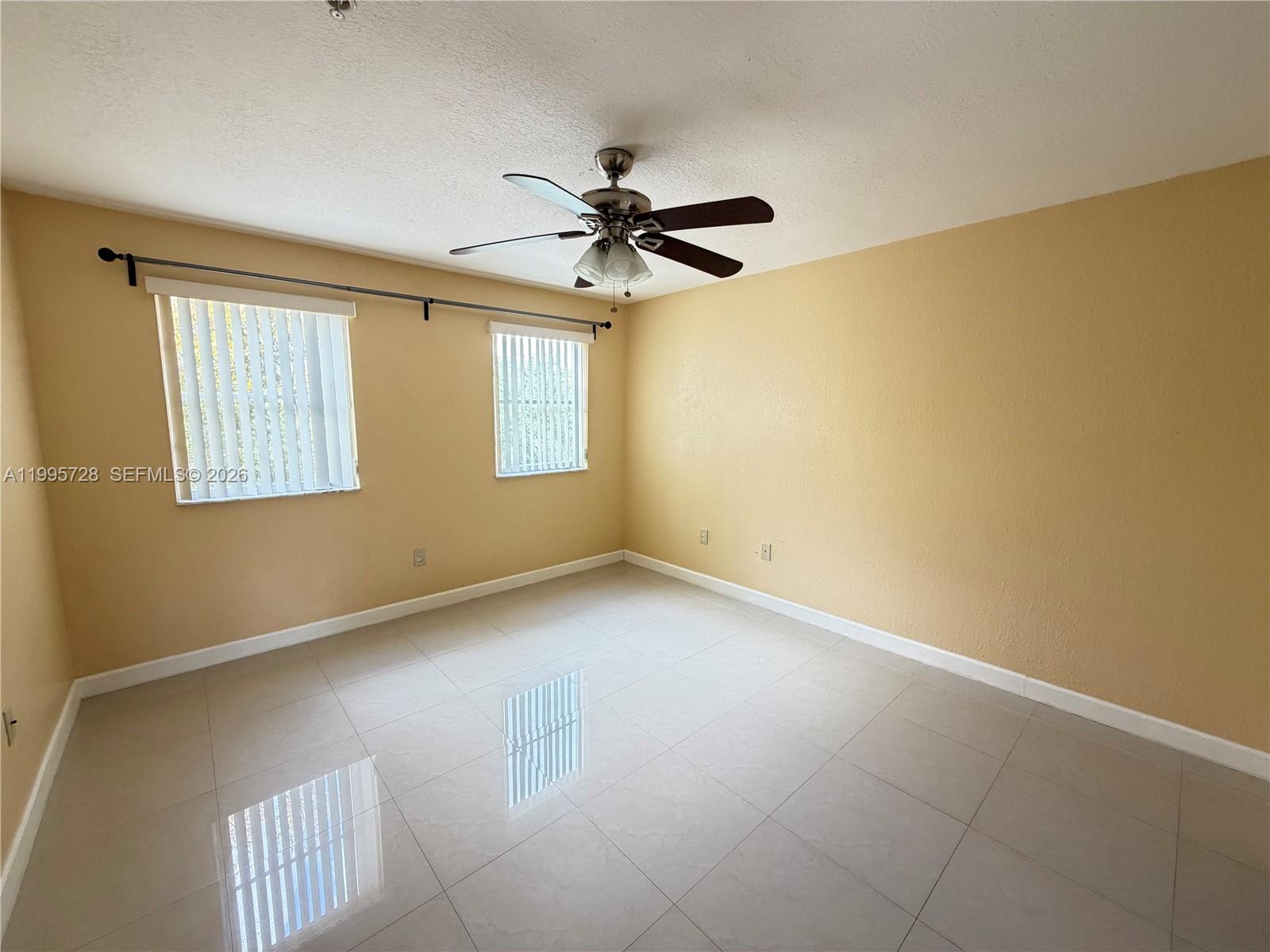 7080 Northwest 177th Street, Unit 20913 Hialeah, FL 33015 - Photo 13 of 15 a view of an empty room with a window