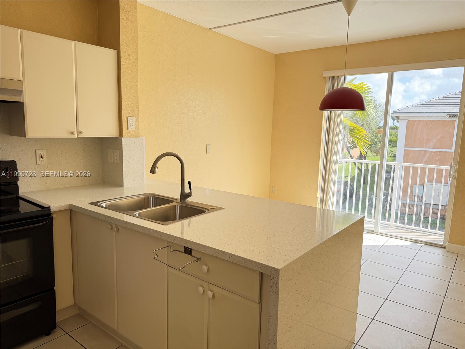 7080 Northwest 177th Street, Unit 20913 Hialeah, FL 33015 - Photo 4 of 15 a kitchen with a sink and cabinets