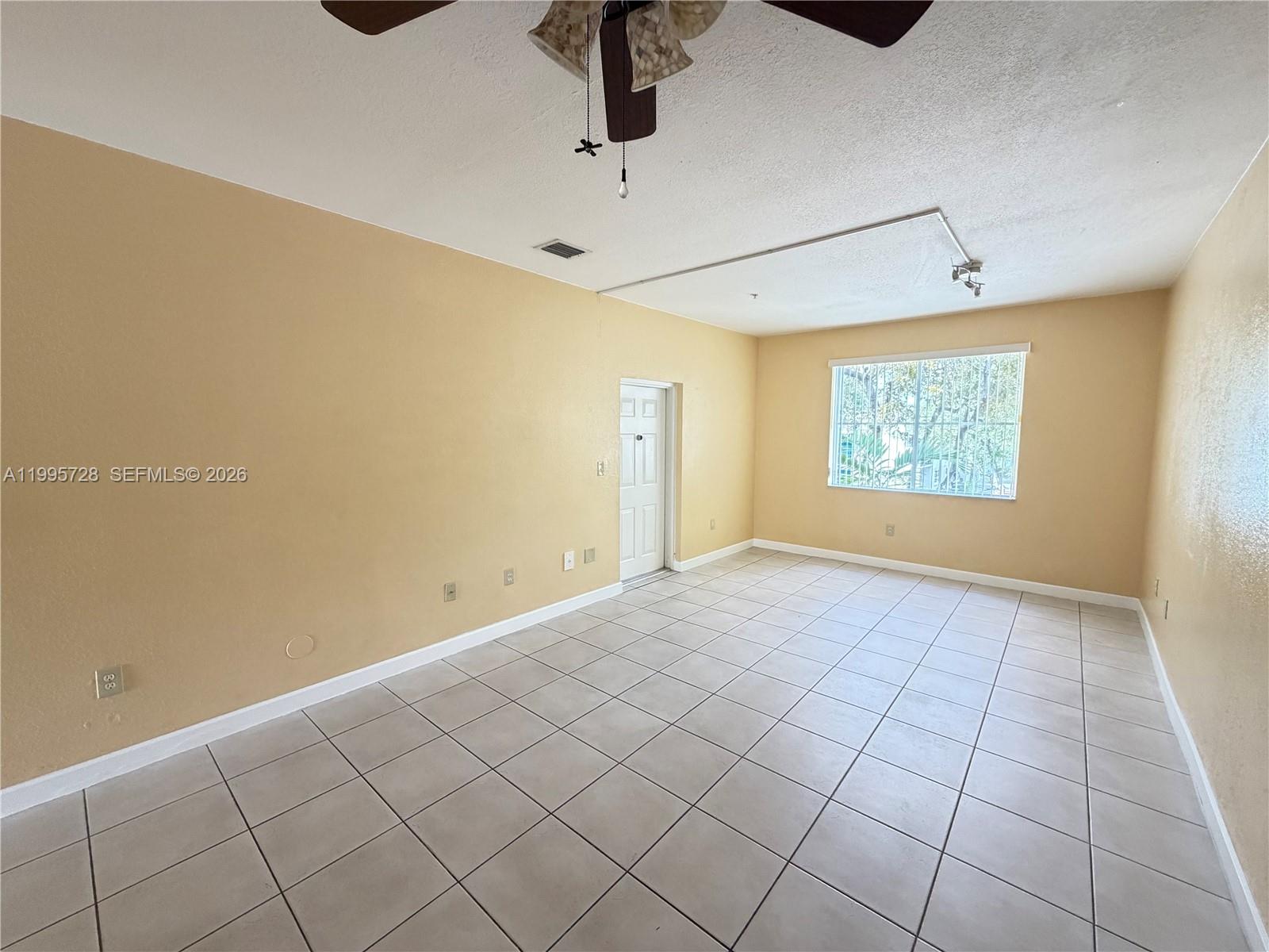 7080 Northwest 177th Street, Unit 20913 Hialeah, FL 33015 - Photo 7 of 15 a view of an empty room and window