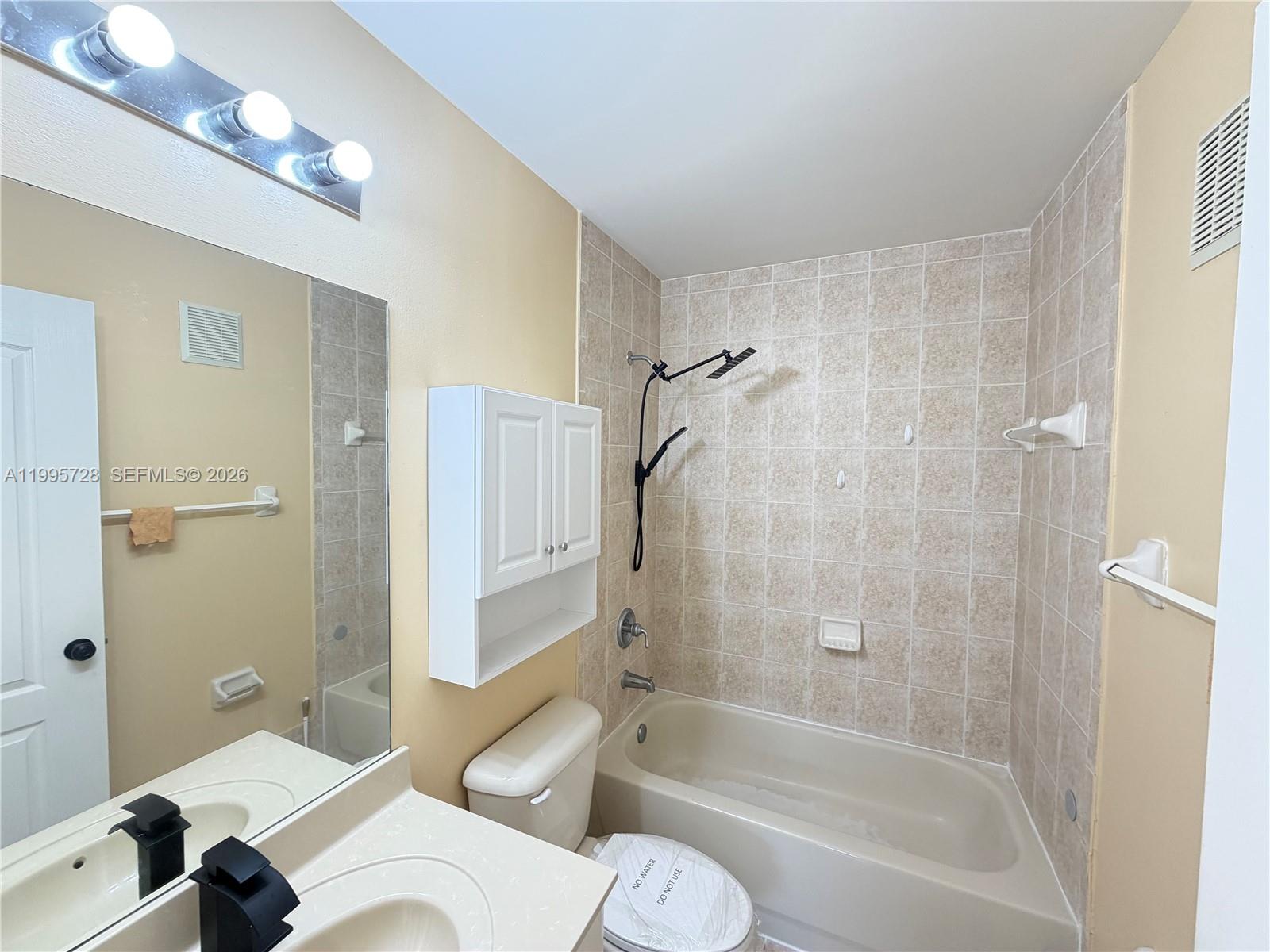 7080 Northwest 177th Street, Unit 20913 Hialeah, FL 33015 - Photo 10 of 15 a bathroom with a sink toilet and shower