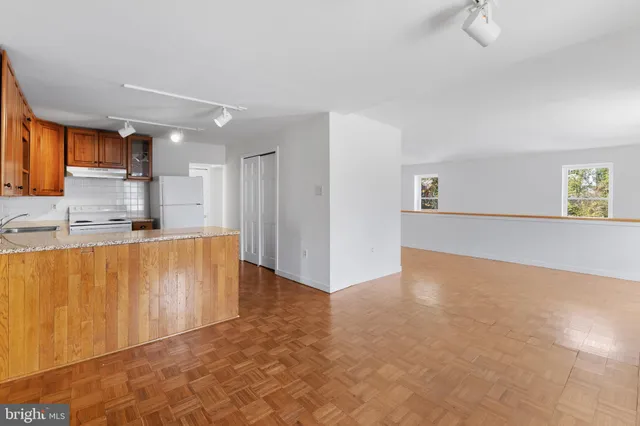 a view of kitchen with stainless steel appliances granite countertop a refrigerator sink and cabinets