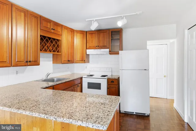 a kitchen with stainless steel appliances granite countertop a refrigerator sink and cabinets
