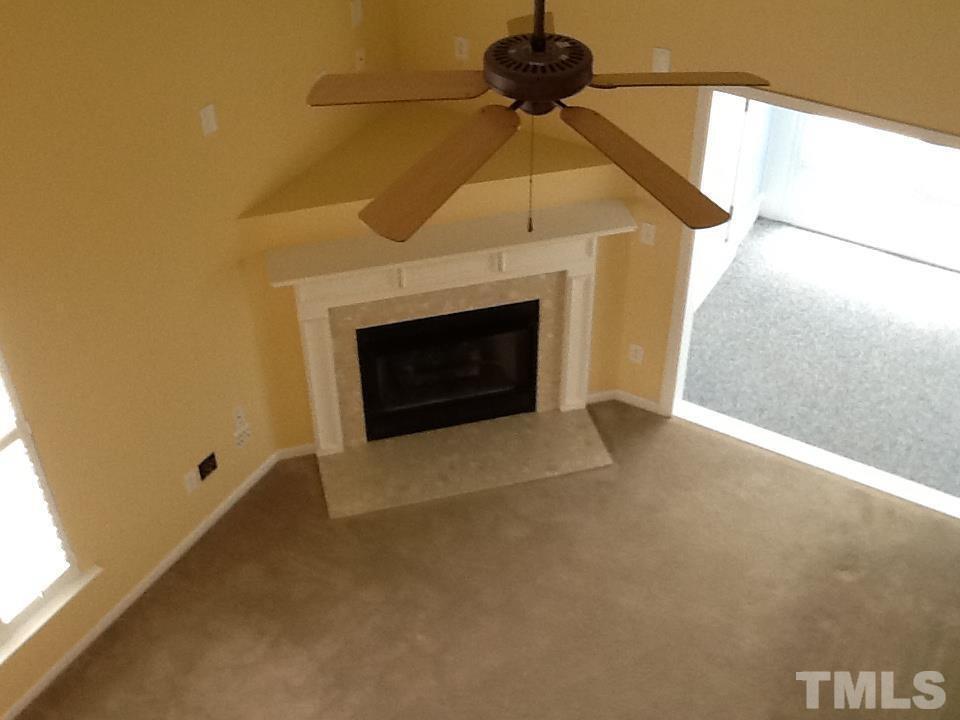 11417 Shadow Elms Lane Raleigh, NC 27614 - Photo 12 of 19 a view of an empty room with a fireplace