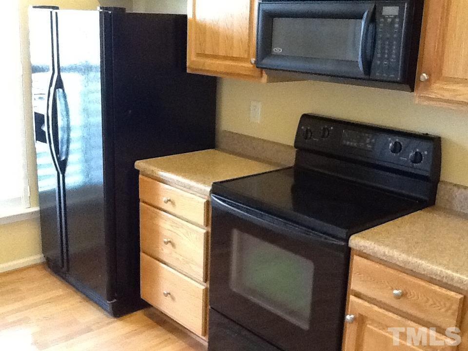 11417 Shadow Elms Lane Raleigh, NC 27614 - Photo 18 of 19 a kitchen with stainless steel appliances granite countertop a stove and a refrigerator