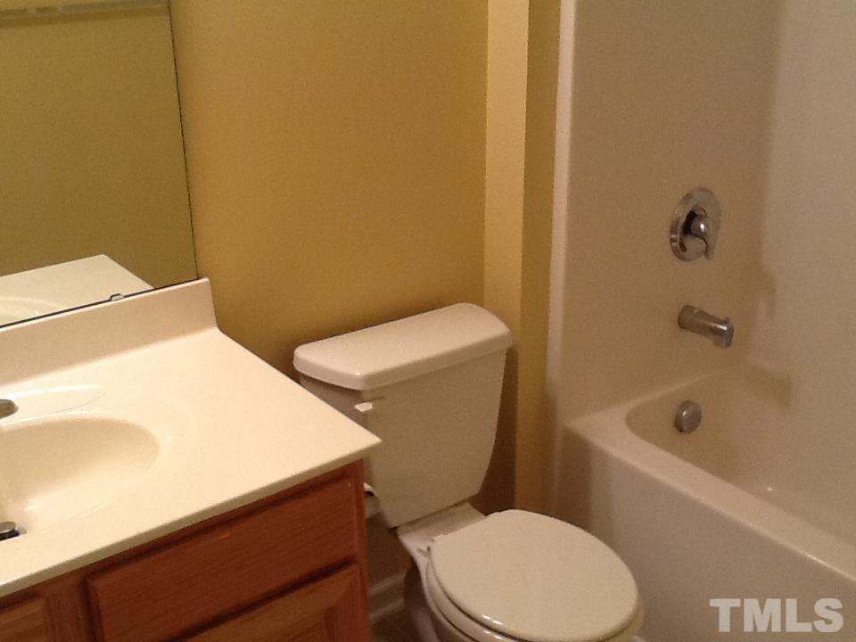 11417 Shadow Elms Lane Raleigh, NC 27614 - Photo 19 of 19 a white toilet and tub sitting next to a bathroom sink