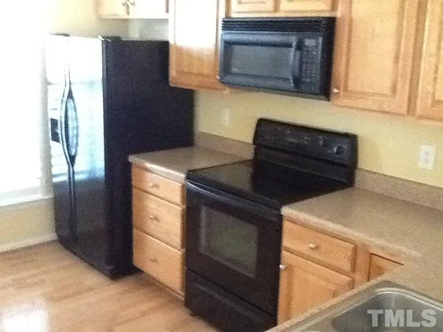a stove top oven sitting inside of a kitchen