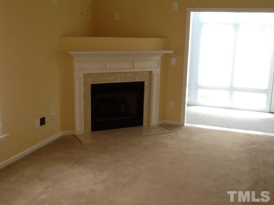 11417 Shadow Elms Lane Raleigh, NC 27614 - Photo 7 of 19 a view of an empty room with a fireplace