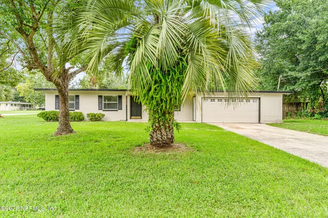 a front view of house with yard and green space
