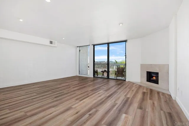 a view of an empty room with glass door and balcony