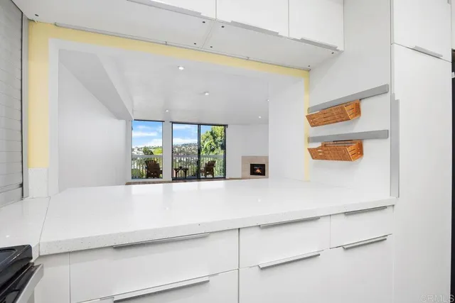 a kitchen with stainless steel appliances a sink and a large window